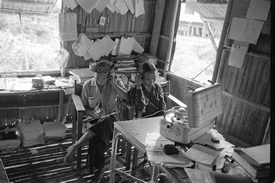 Itolina and Mabok listening to their tape recordings in the office of the research station (1962).